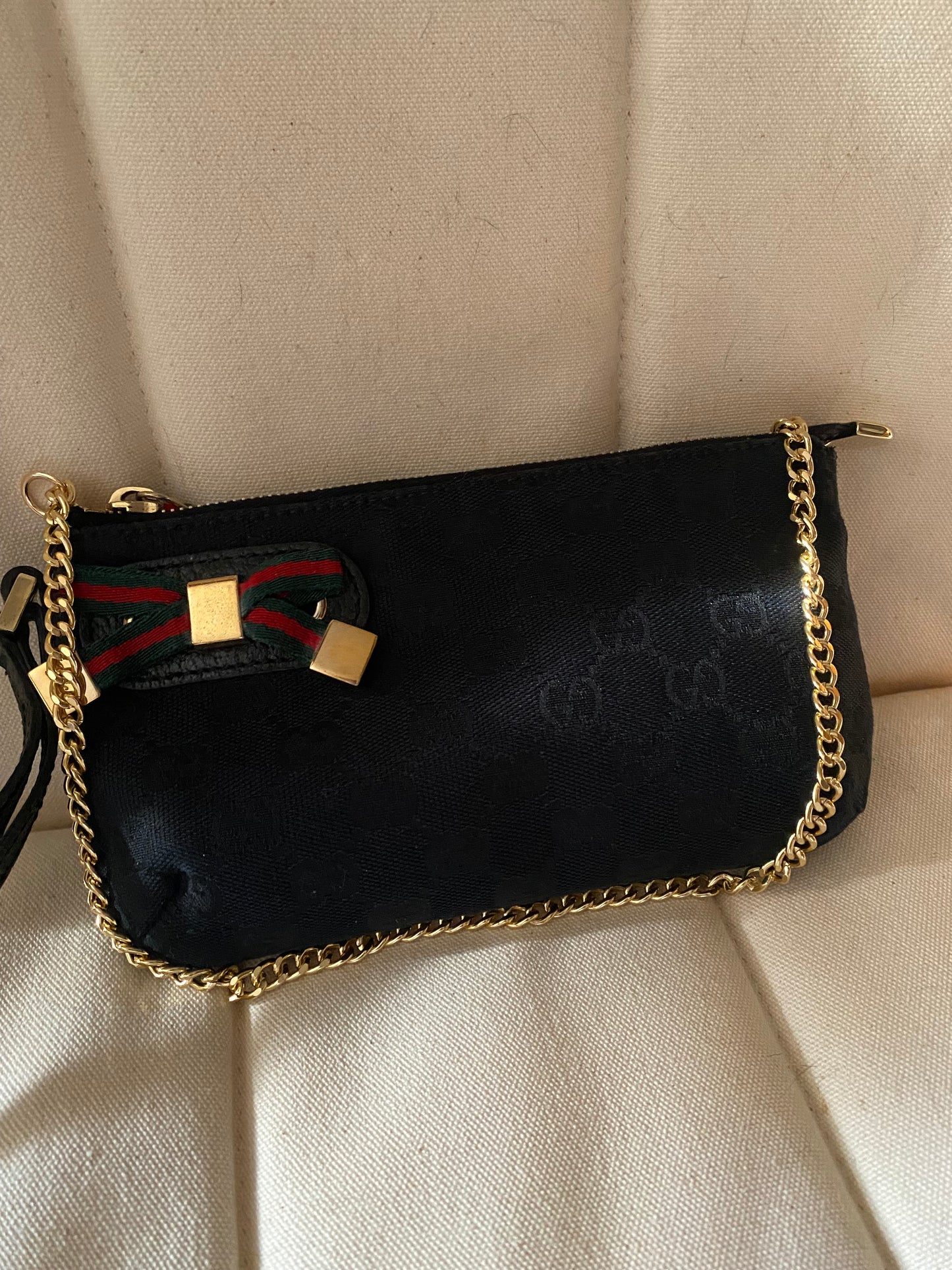 Gucci Pochette monogram  nera canvas con fiocco