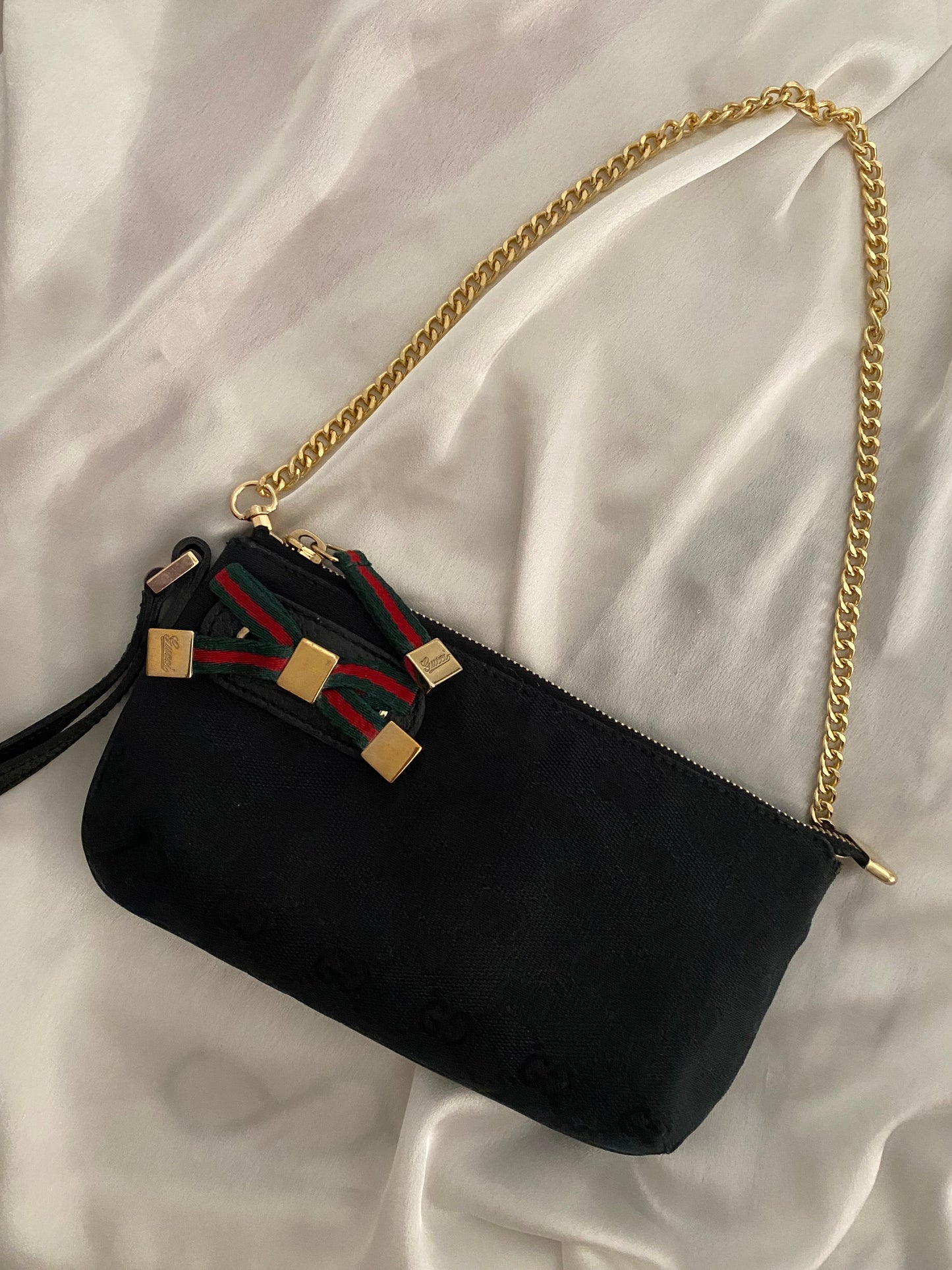 Gucci Pochette monogram  nera canvas con fiocco